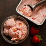 Strawberry Cottage Cheese Ice Cream served in a bowl with fresh strawberries